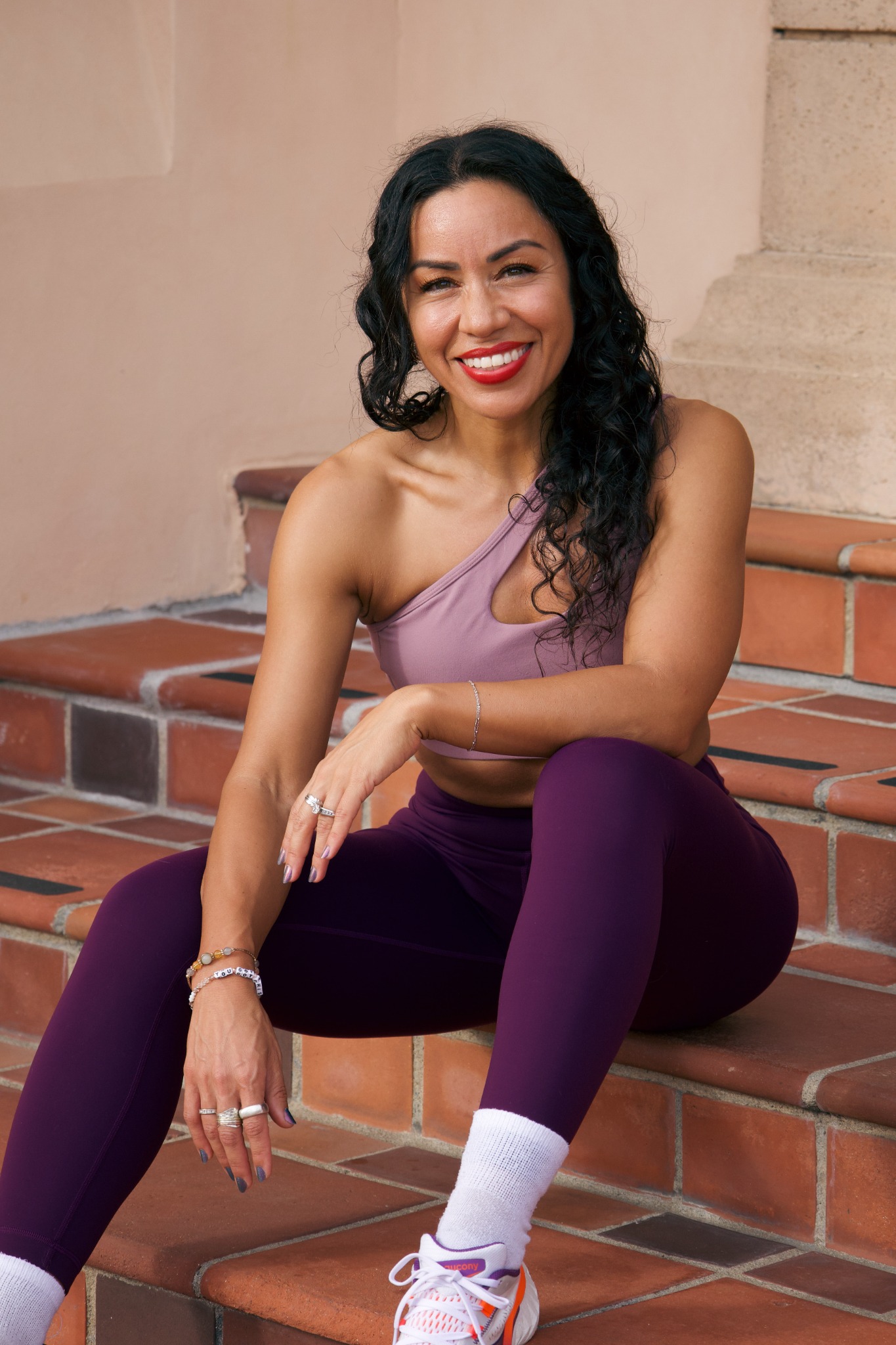 Marissa smiling in plum activewear